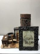 A tray of two heavily carved wooden vases, wooden candlesticks,