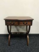An inlaid mahogany regency style table fitted with two drawers