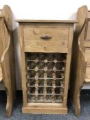 A reclaimed pine bottle rack fitted with a drawer