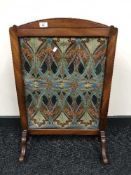 A late Victorian mahogany fire screen with Art Nouveau fabric