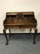 A mahogany writing desk on claw and ball feet