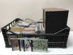 A box of cds and pair of B & O Beovox 1702 speakers