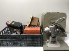A basket containing Bell and Howell 8mm Projector, camera, cine camera,