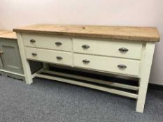 A painted pine dresser base fitted with four drawers