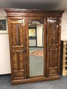 A late Victorian walnut mirror door wardrobe
