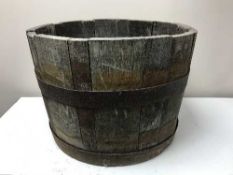 A wooden iron bound barrel planter