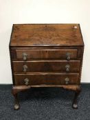 A mahogany bureau on claw and ball feet