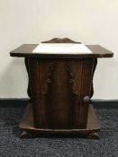 An oak marble topped bedside table