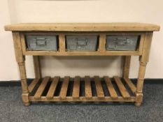 A pine farmhouse table fitted with three galvanised drawers