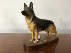 A Beswick china figure : Alsatian, model number 2587, on wooden plinth, overall height 22.4 cm.