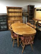A pine dining room suite comprising of extending table and six chairs and triple door dresser