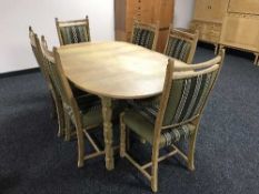 A blonde oak dining table and six chairs