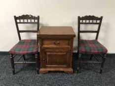 A pair of carved Edwardian bedroom chairs and a pine bedside cabinet