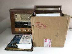 A walnut cased Bush valve radio, picture frames, wooden rack of records,