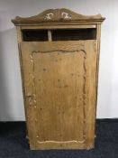 An antique stripped pine gent's wardrobe