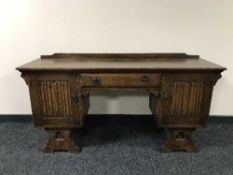 An oak linen fold knee hole dressing table