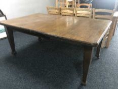 A late Victorian oak wind out table fitted two leaves
