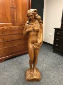 A carved pine figure of a nude maiden