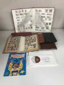 A box of assorted stamp albums and stamps, coin albums,