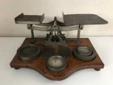 A set of antique postal scales with weights