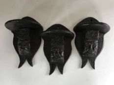 Three antique carved oak wall shelves