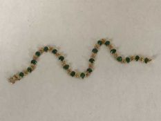An 18ct gold emerald bracelet