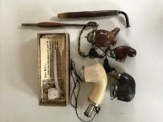 A collection of pipes including a boxed Pipe Lore clay pipe