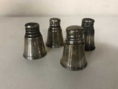 A set of four silver pepperettes