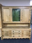 A blonde oak leaded door dresser
