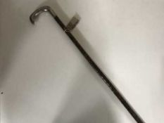 A silver handled walking stick