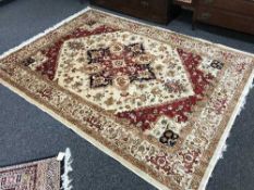 A Persian Heriz rug on beige ground, 230cm by 160cm.