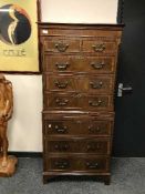 A reproduction mahogany double chest with brushing slide