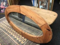 An oval pine coffee table and mirror