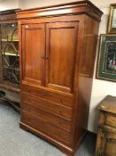 A reproduction mahogany entertainment cabinet fitted four drawers