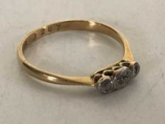 An 18ct gold three stone diamond ring