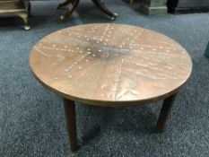 A circular copper topped table by Raymond Hodgkiss and company