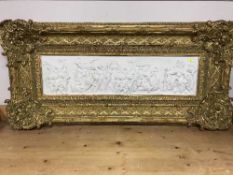A gilt framed panel depicting figures