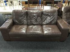 A brown leather two seater and matching three seater settee