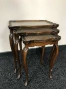 A nest of three walnut tables