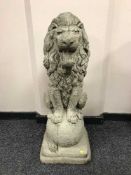 A garden figure of a lion on ball