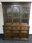 A carved oak triple door dresser