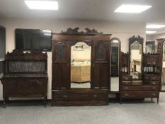 A three piece Victorian mahogany bedroom suite comprising of triple wardrobe,