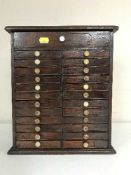 An antique mahogany multi drawer miniature collector's chest