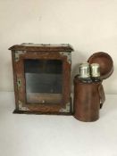 An early 20th century oak smoker's cabinet and three hip flasks in leather case