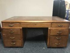 A 20th century oak twin pedestal partner's desk