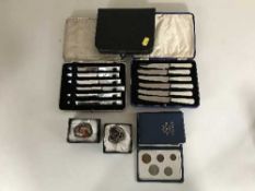 A basket of two cases of stainless steel fruit knives, box of costume jewellery,