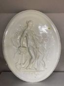 A large oval plaster plaque of a Goddess and Cherub