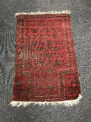 An Afghan prayer rug on red and black ground