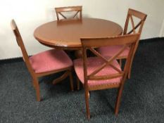 A circular dining table by Morris of Glasgow and four chairs