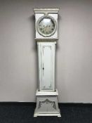 A continental white and gilt painted long cased clock with pendulum and weights